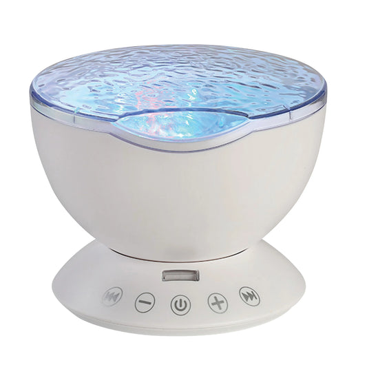 A white electronic ocean wave projector with speaker in a bowl-shaped body, a textured translucent top emitting a blue glow, and a circular control base with five buttons.