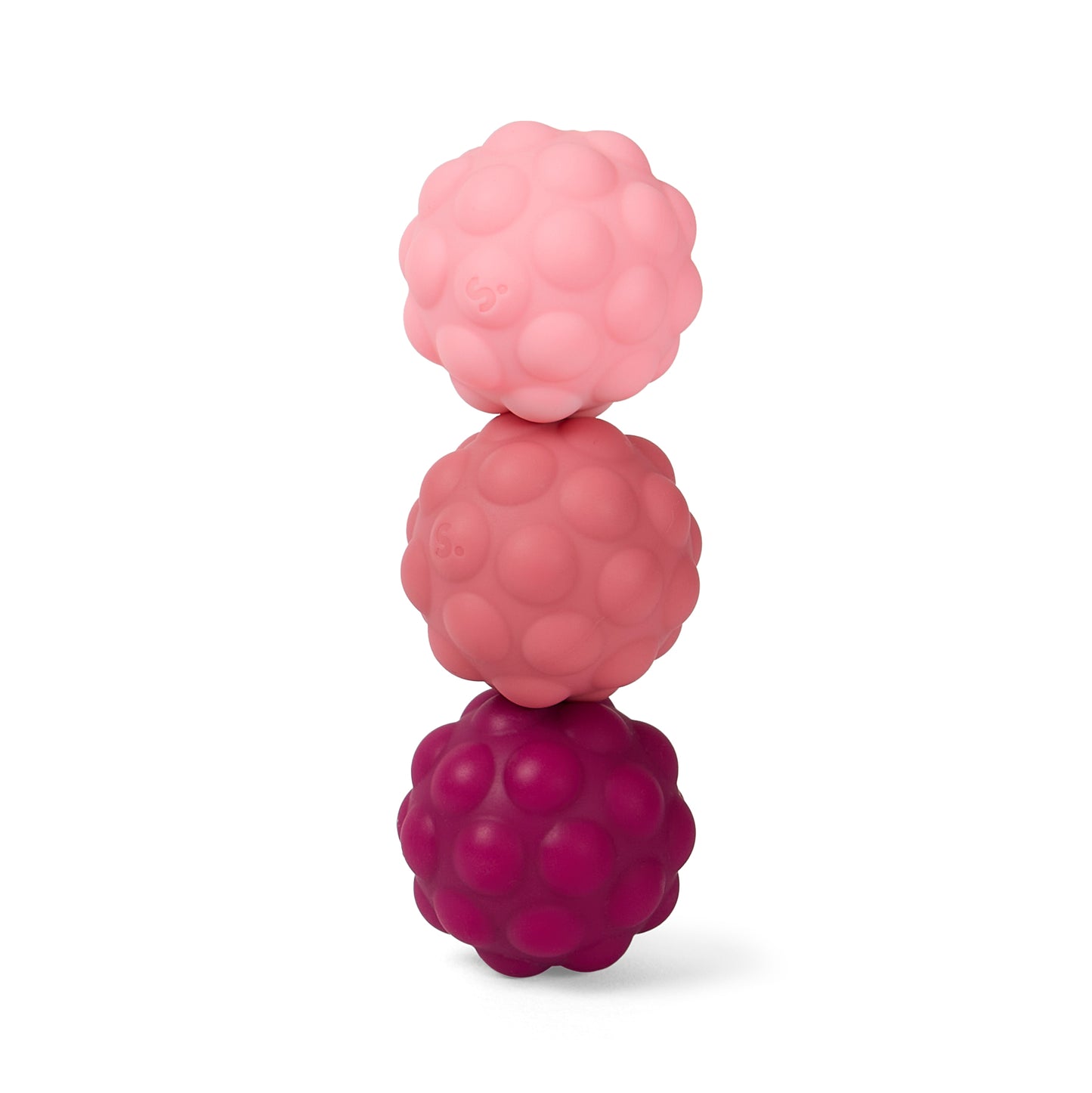 Stack of three odds purple and pink textured silicone balls on a white background