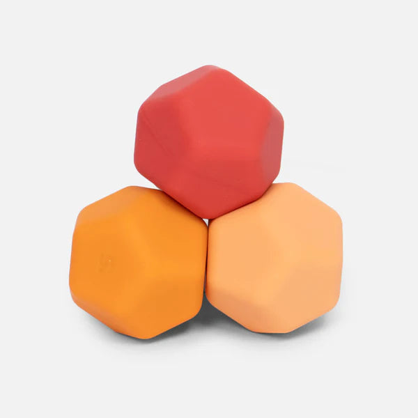 Odds orange planes are 3 hexagonal silicone magnets in red and orange on a light gray background