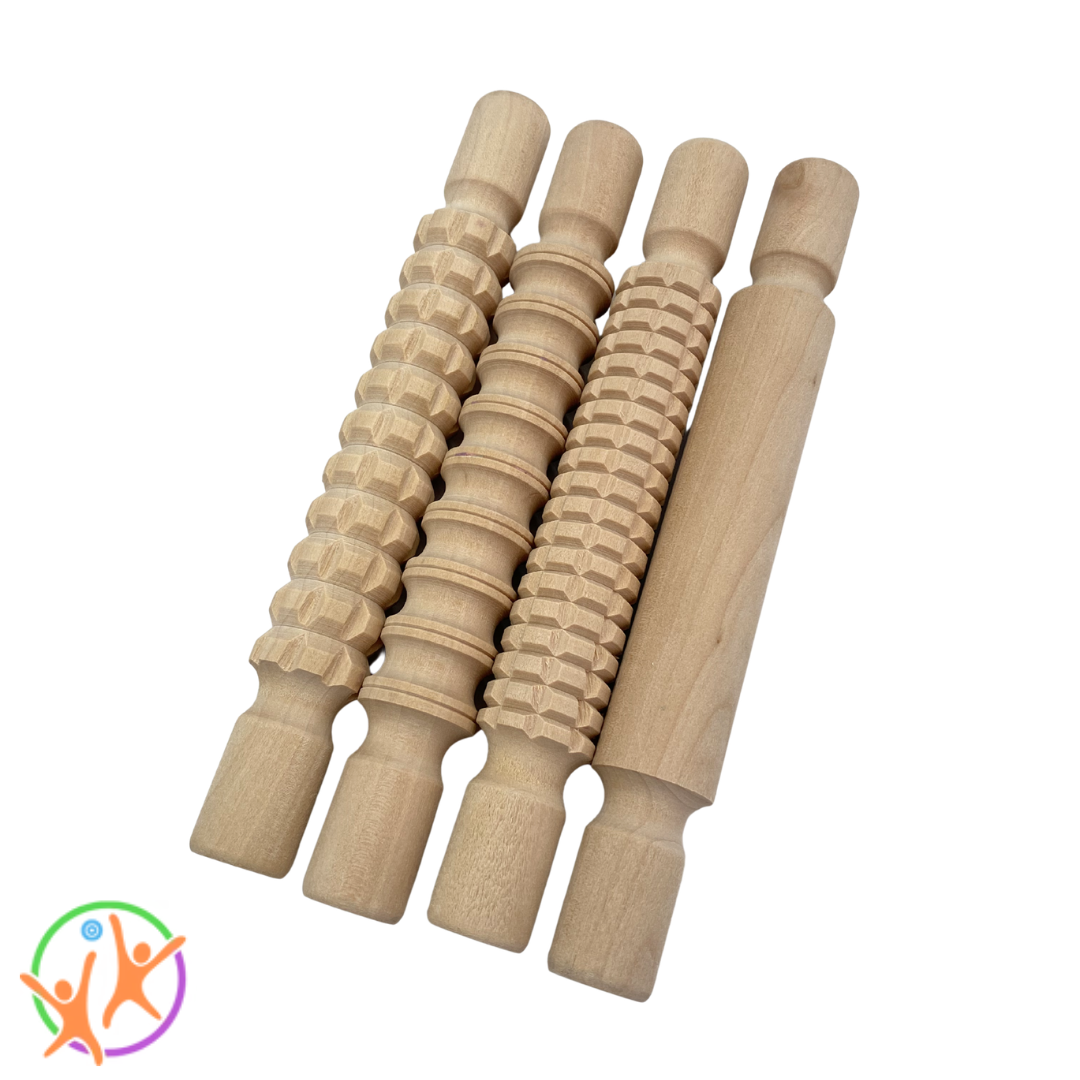 Set of small wooden rolling pins with textured patterns on a white  background
