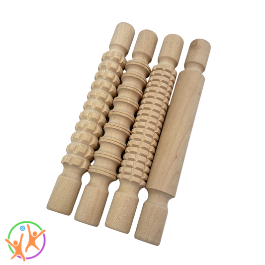 Set of small wooden rolling pins with textured patterns on a white  background