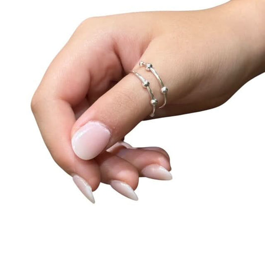 Kaiko Riven Fidget Ring wrap around design with 4 balls worn on the thumb