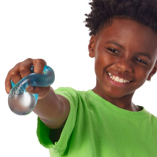 Child squeezing a blue Nee Doh Nice Cube 