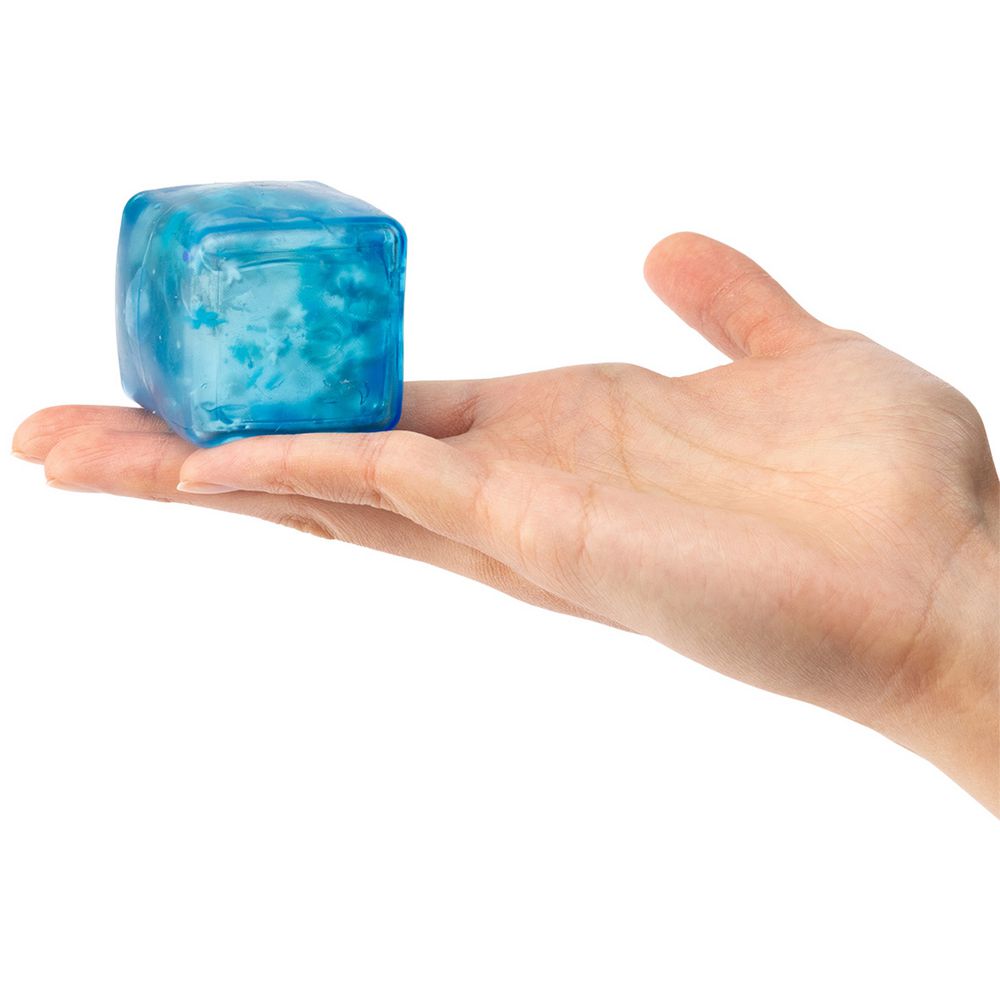 Hand holding a sensory sprouts blue jelly cube against a white background