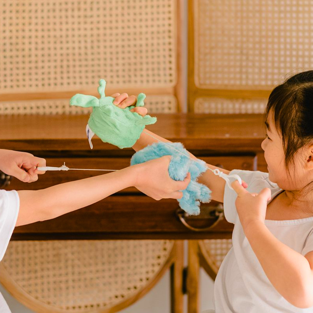 Two children playing with Senseez vibrating handheld sensory toys in green turtle and blue jellyfish textures