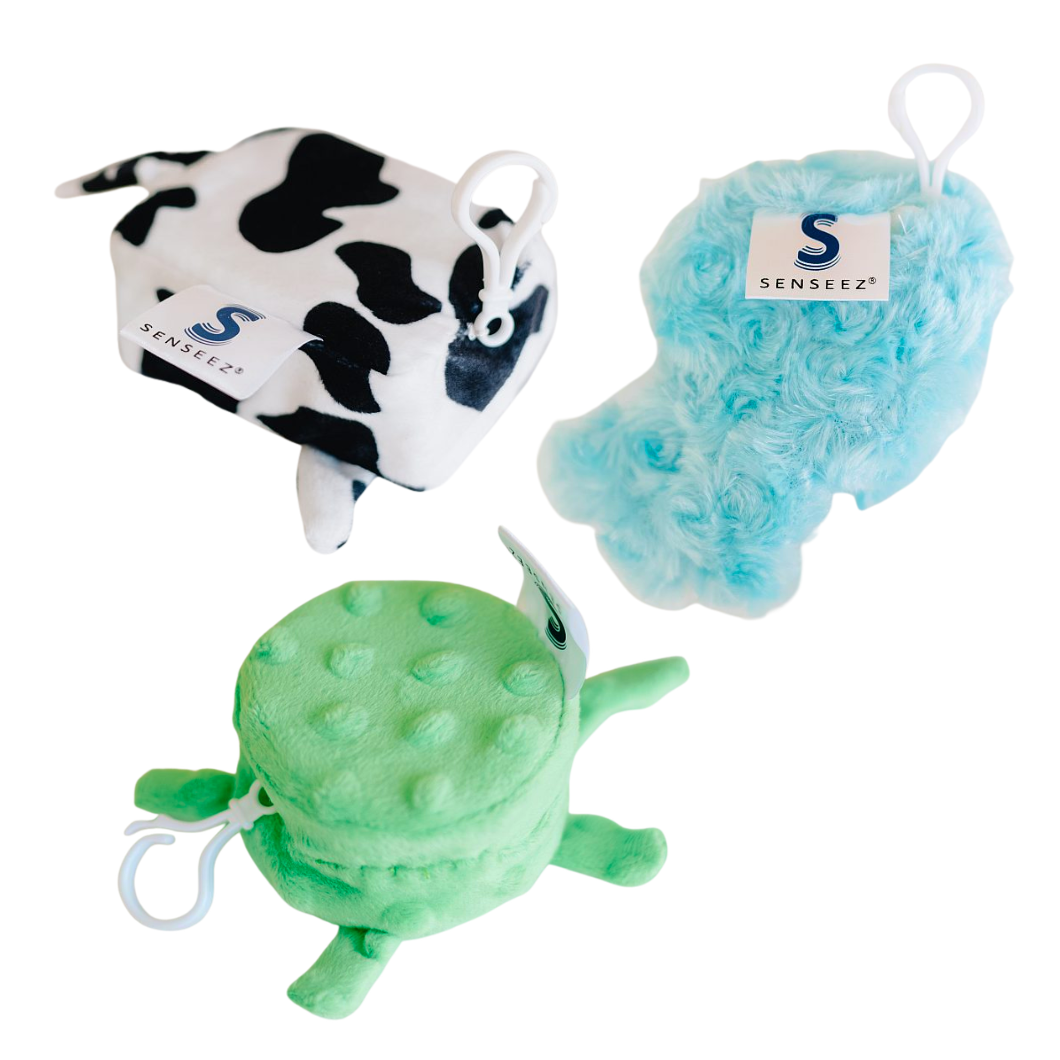 Three Senseez vibrating handheld sensory toys in cow print, blue jellyfish, and green turtle textures. Each pocket-sized fidget features a white pull-string clip for battery-free, drawcord-activated vibration to help children focus.