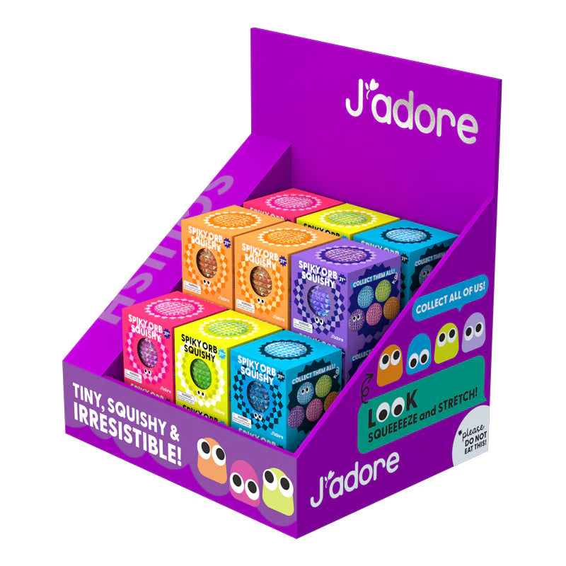 Display box of colourful J'adore squishy toys with a purple background