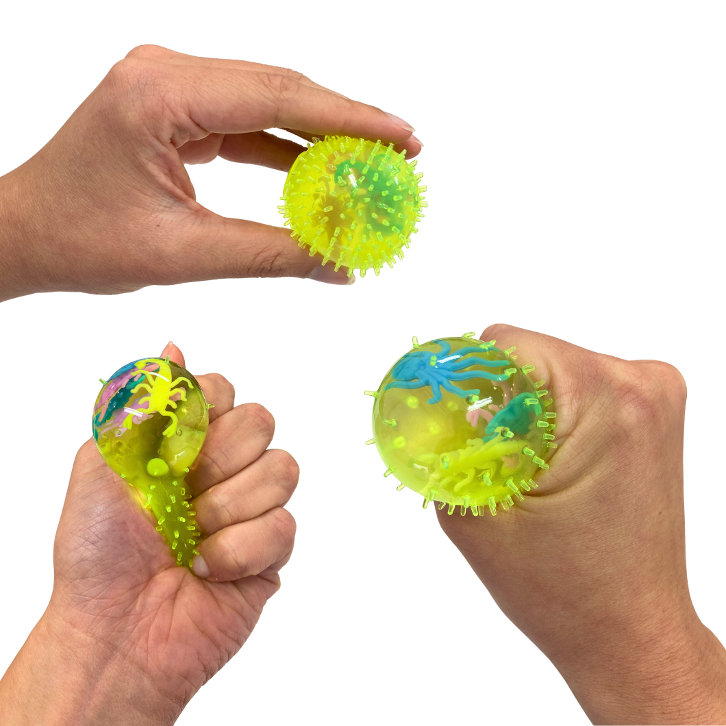 Hand holding and squishing a Squishy Splat Stress Ball on a white background