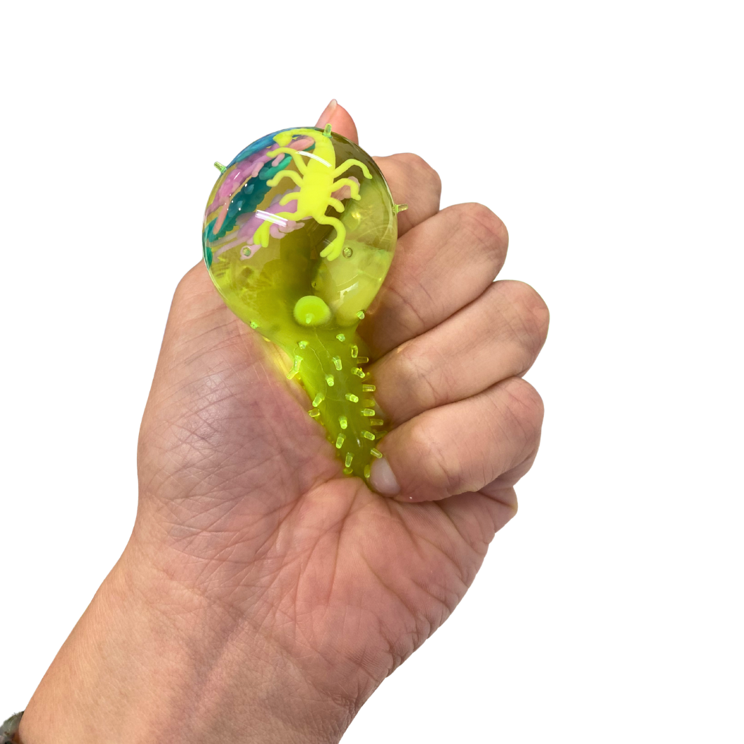 Hand squeezing a squishy splat stress ball against a white background