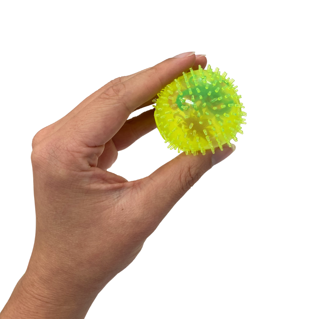 Hand holding a squishy splat stress ball on a white background