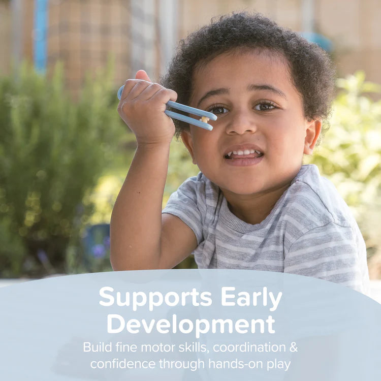 Child holding something in larger silicone tweezers toy with text about early development and fine motor skills