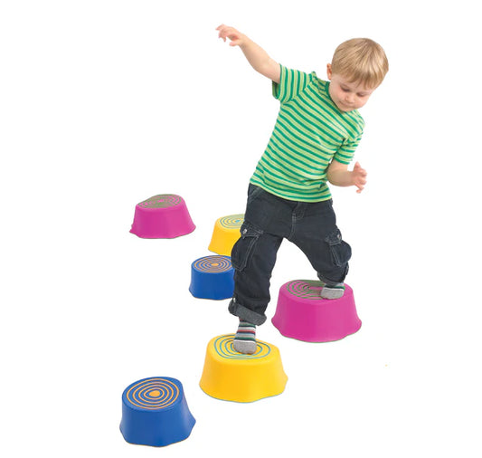 Child balancing on with colourful step stumps 