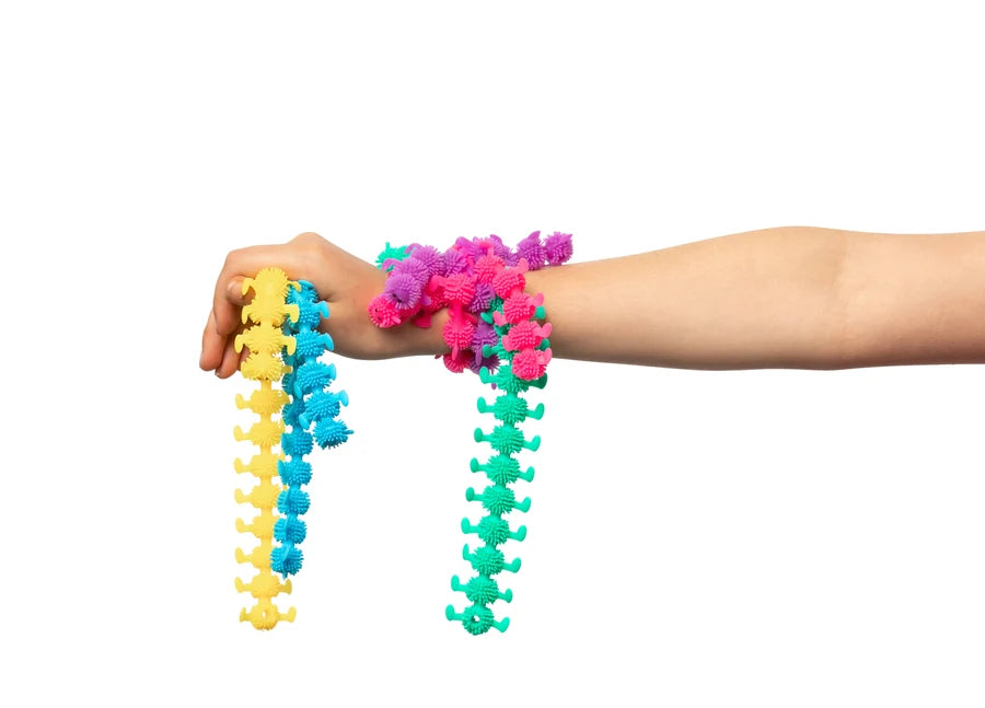 Colorful stretch caterpillar fidget toys held by a person on a white background