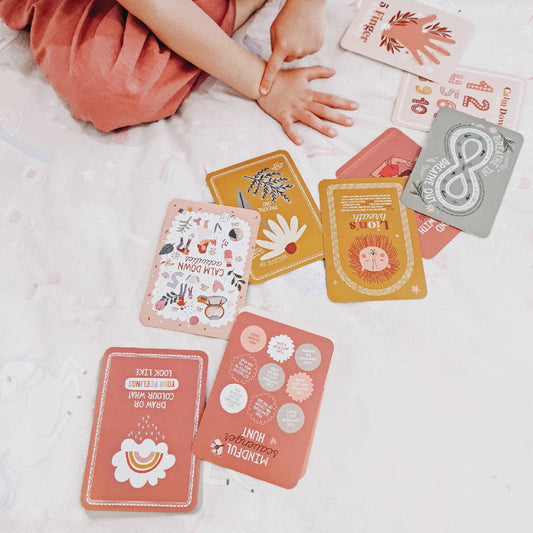 Colorful calm down flash cards on a light surface with a child's hand implementing a strategy by the creative Sprout