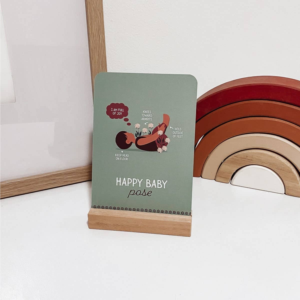 Happy baby yoga pose pose flash card on stand