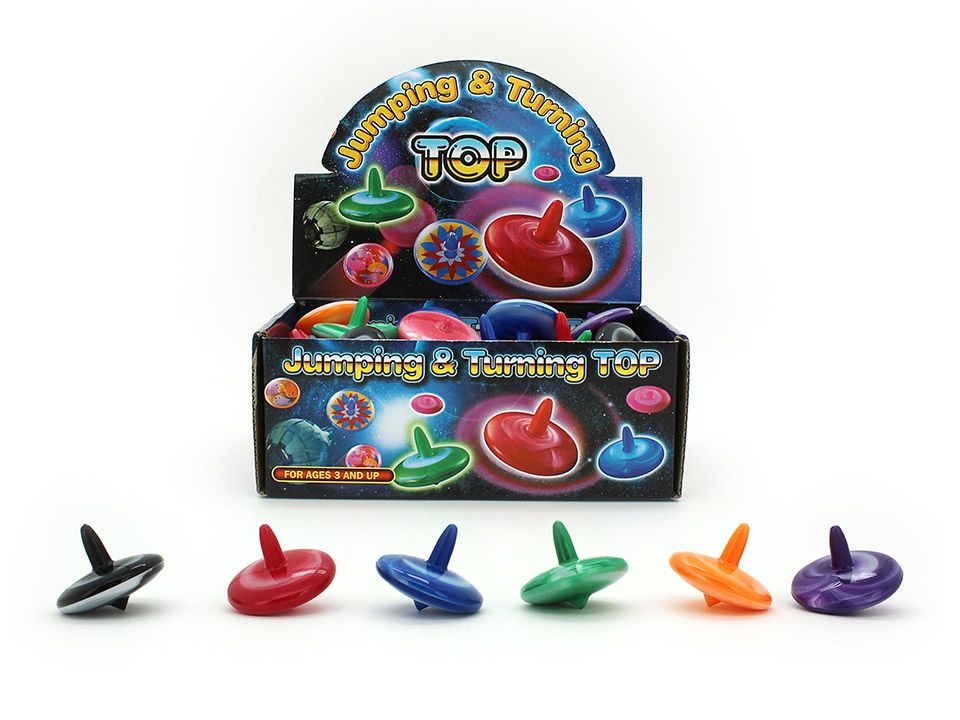A collection of six vibrant tie-dyed spinning tops made of durable plastic are lined up in front of a space-themed display box. The tops are assorted colors including black, red, blue, green, orange, and purple.