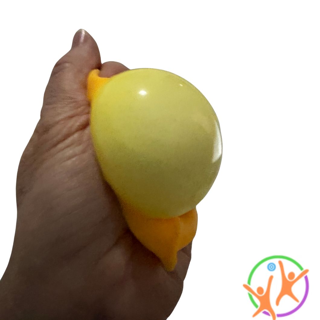 A hand squeezing a small yellow cheese stress toy against a plain white background.