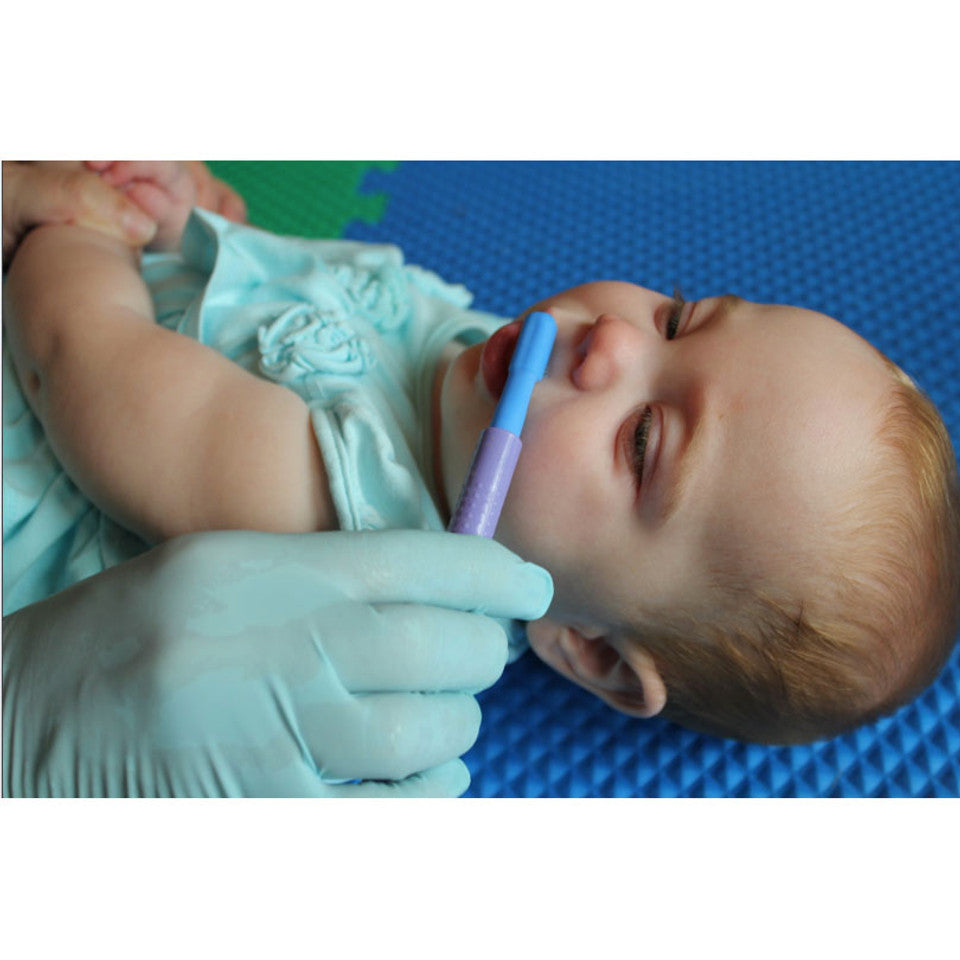 Blue brush tip working on lip closure on a baby laying on back