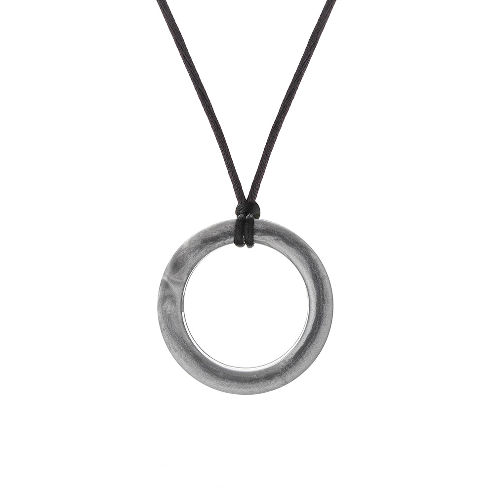 Silver chewigem realm ring pendant on a black cord against a white background
