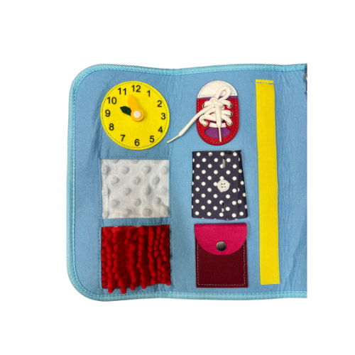 close up of half of the Children's activity blanket with clock, shoelaces, button pockets, and tactile fabric
