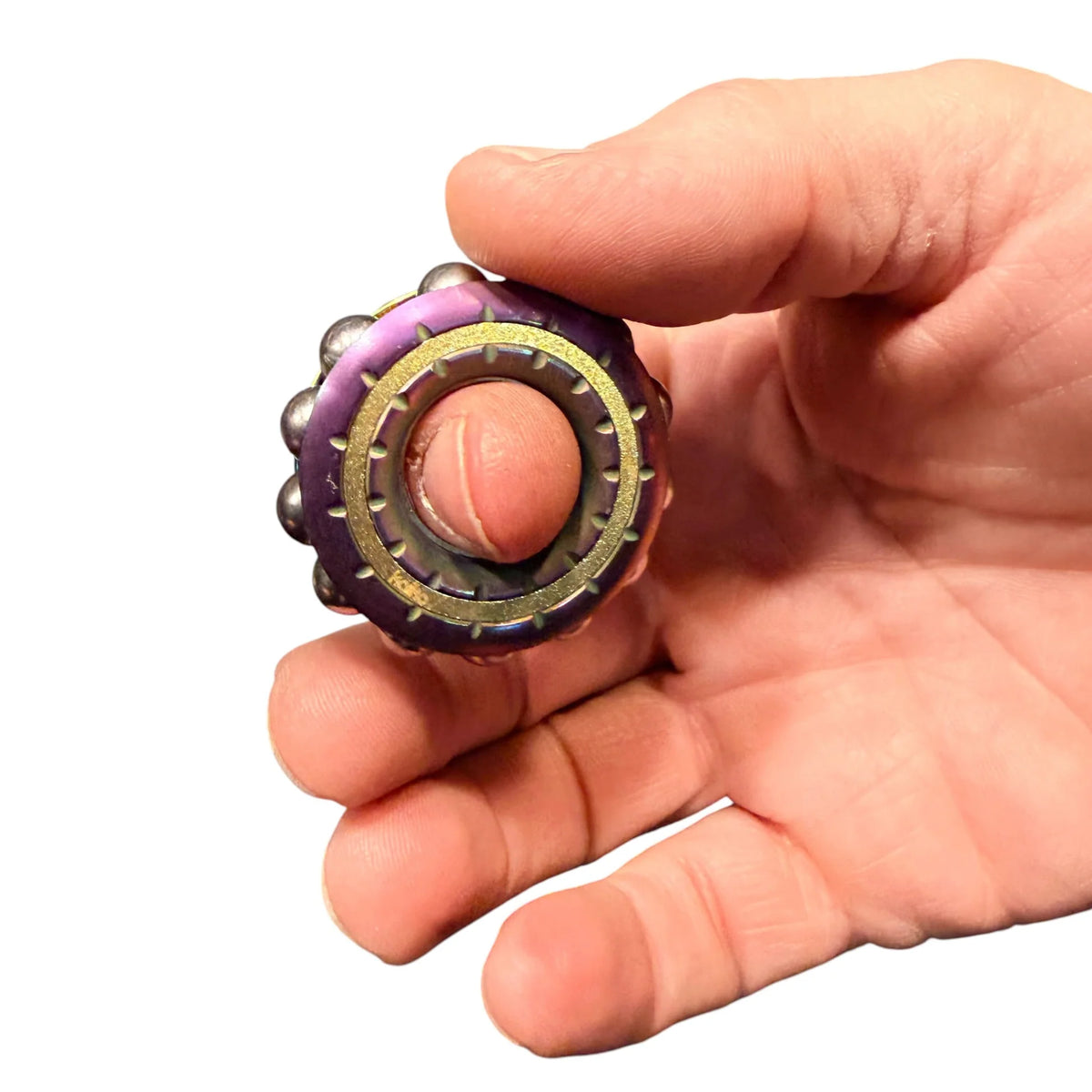 Kaiko Freewheel spinner sitting over a finger like a ring