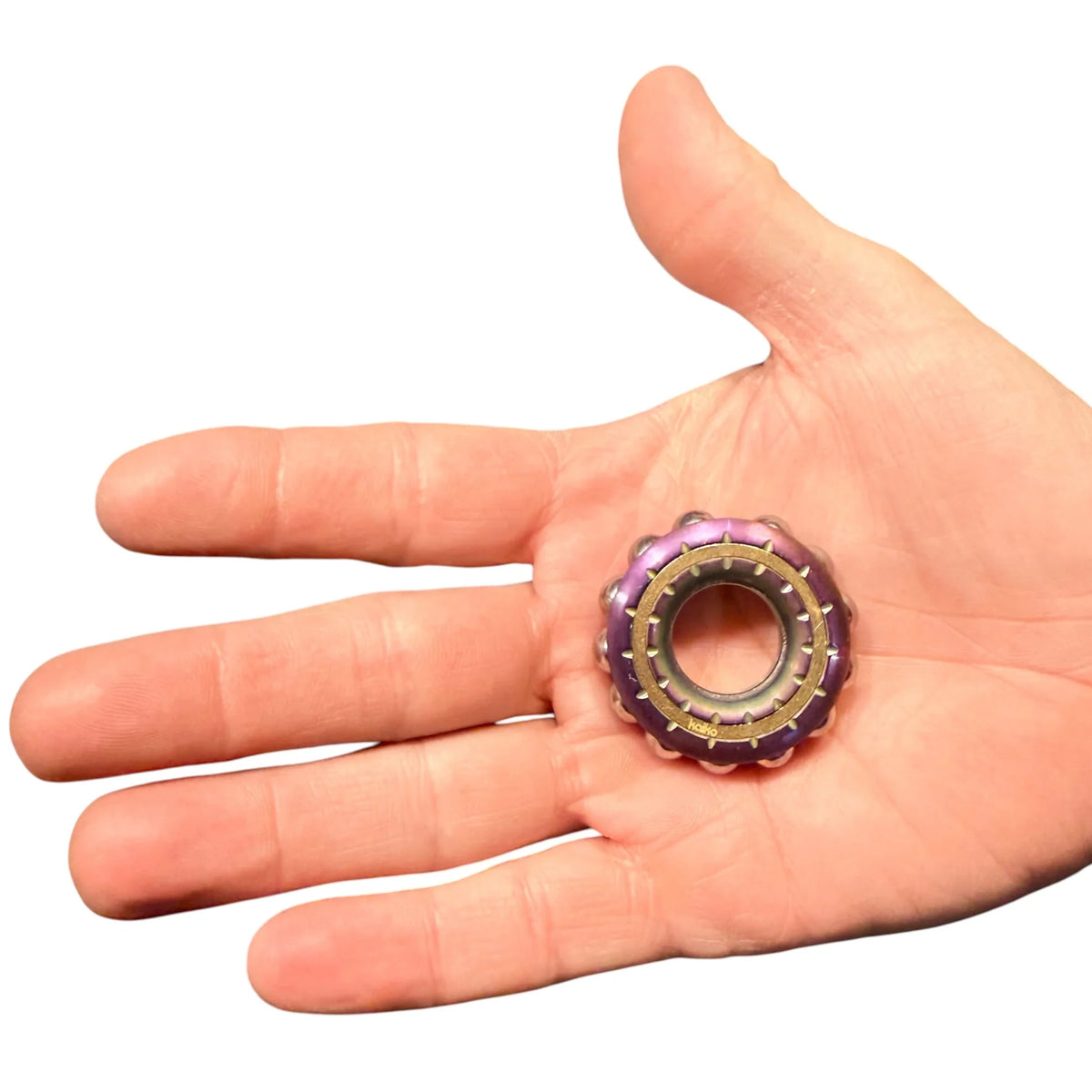 metal donut shaped fidget wheel spinner in palm of hand