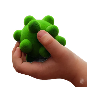 tactile rubber stress ball in a childs hand