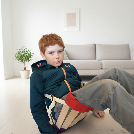 Child rocking in the HowdaHUG Sensory Chair - Background minimalist lounge room generated in AI