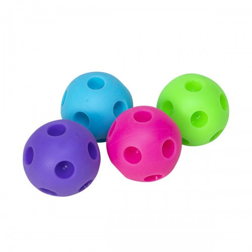 Four colorful happy snappy needoh balls covered in round grooves