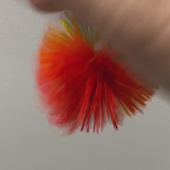 Stimming with the pom pom ball clip over the finger