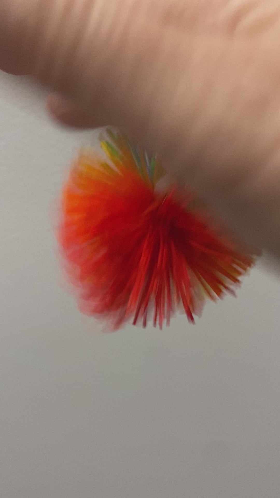 Stimming with the pom pom ball clip over the finger