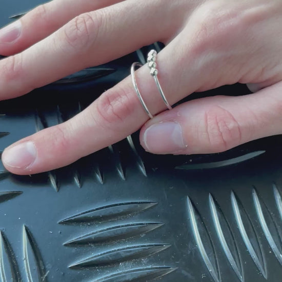 Spin the ring and slide the balls on the Riven Kaiko Fidget RIng