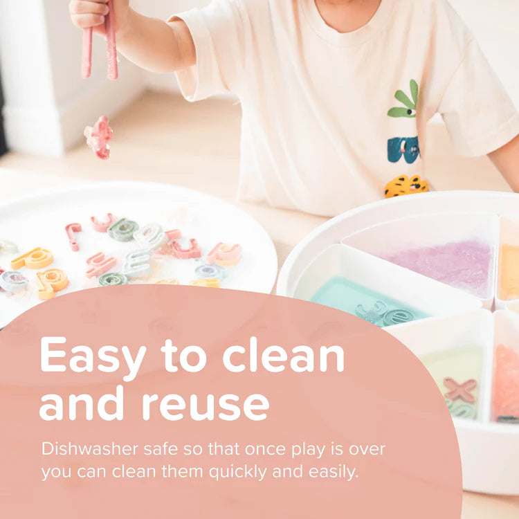 Child playing with silicone letters on a table, with text about cleaning and reuse.