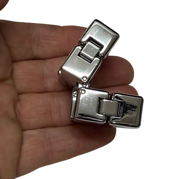 folded infinity cube on fingers
