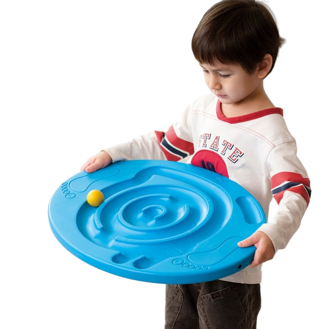 Child holding a blue toy balance disc maze toy with a yellow ball