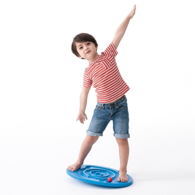 Child standing on a blue weplay balance board with one arm raised 