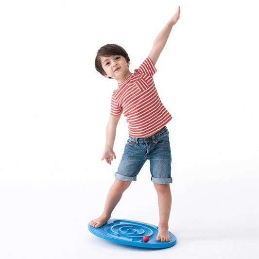 Child standing on a blue weplay balance board with one arm raised 